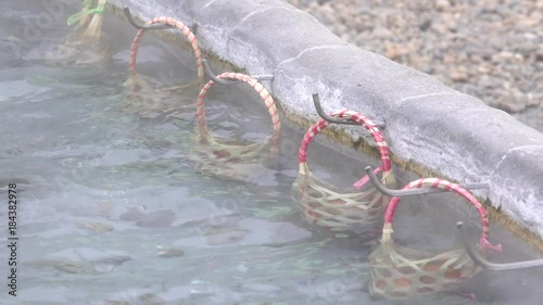 Egg in the basket are boiled in hot springs at sankamphaeng hot springs chiangmai . photo