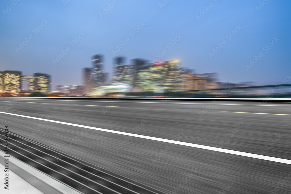 blurry traffic road with cityscape in background, China..