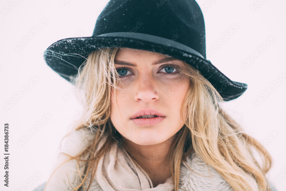 Beautiful winter portrait of young woman in the winter snowy scenery. Beautiful winter portrait of young woman in the winter snowy scenery.