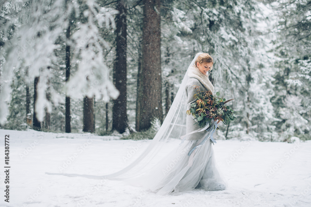 The young pretty girl waits for her lover in the middle of the mountains covered with snow The young pretty girl waits for her lover in the middle of the mountains covered with snow