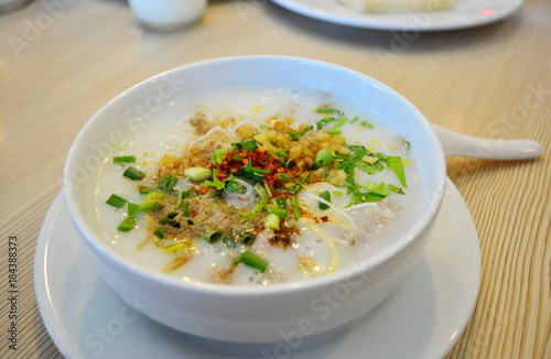 Obraz na płótnie Rice porridge on the white bowl with spoon