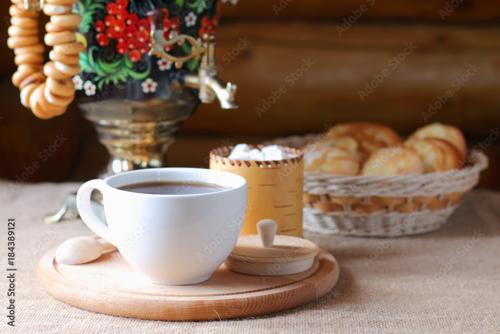 Russian tea from a samovar and pastries in a basket.