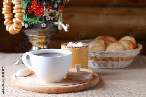 Russian tea from a samovar and pastries in a basket.