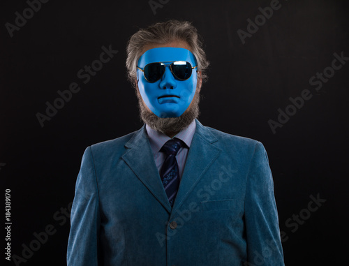 portrait of a man in a blue suit and a blue mask