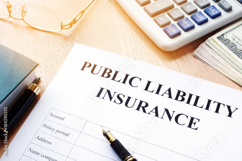 Bild auf Leinwand Public liability insurance policy on an office desk.