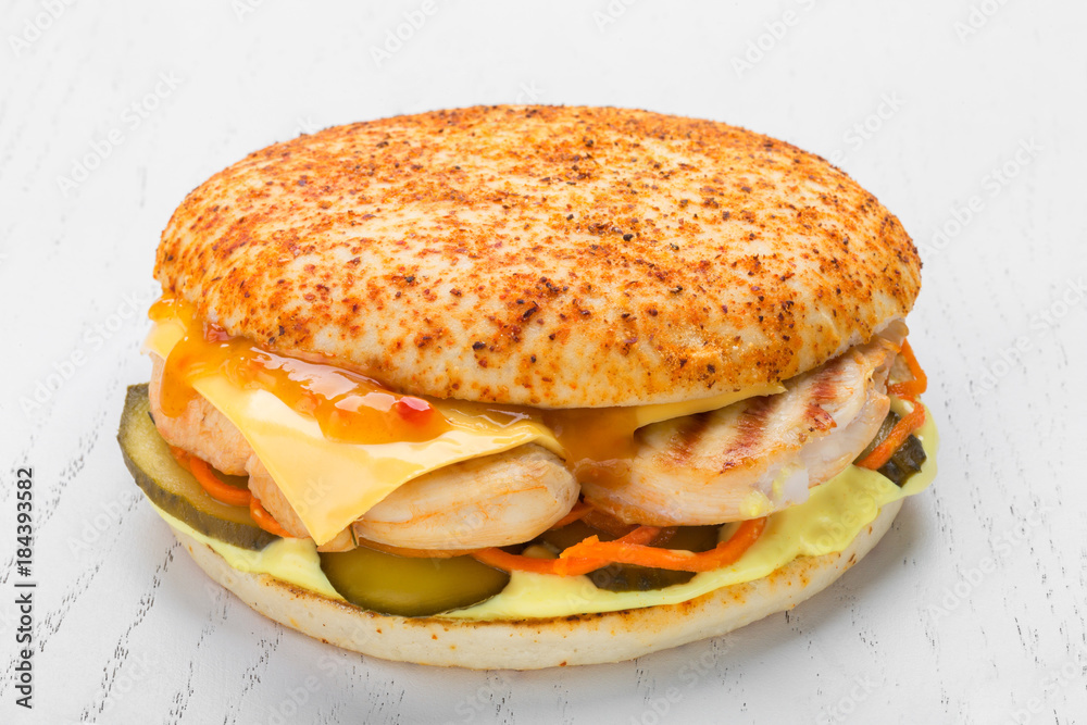 chicken burger with chicken grill, pickle, cheese, carrot