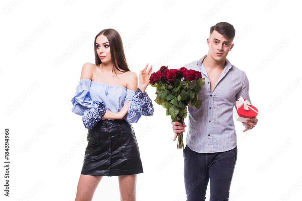 Offense. man and woman with flowers and gift on white background. Offense girl get gift from man on white Offense. man and woman with flowers and gift on white background. Offense girl get gift from man on white