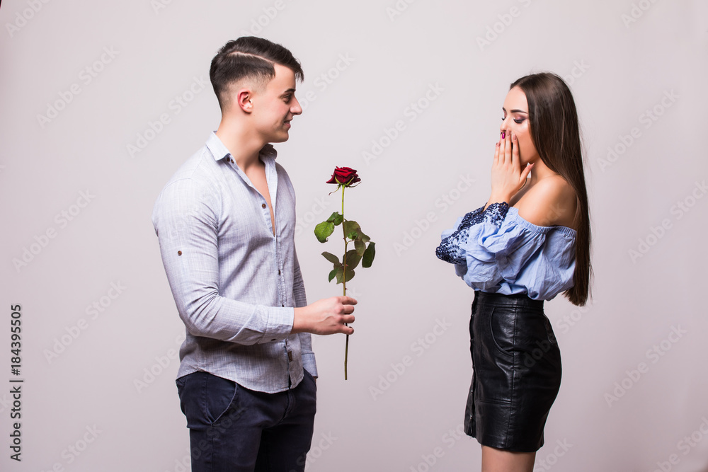 Young couple with rose isolated on white background Young couple with rose isolated on white background