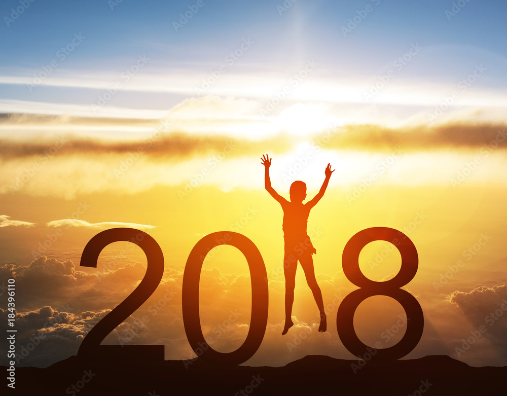 Happy new year card 2018. Silhouette of children girl jump on top of mountain with fantastic sunrise sky. Happy joyful girl jumping as a part of the Number 2018 sign with rising sun  background.