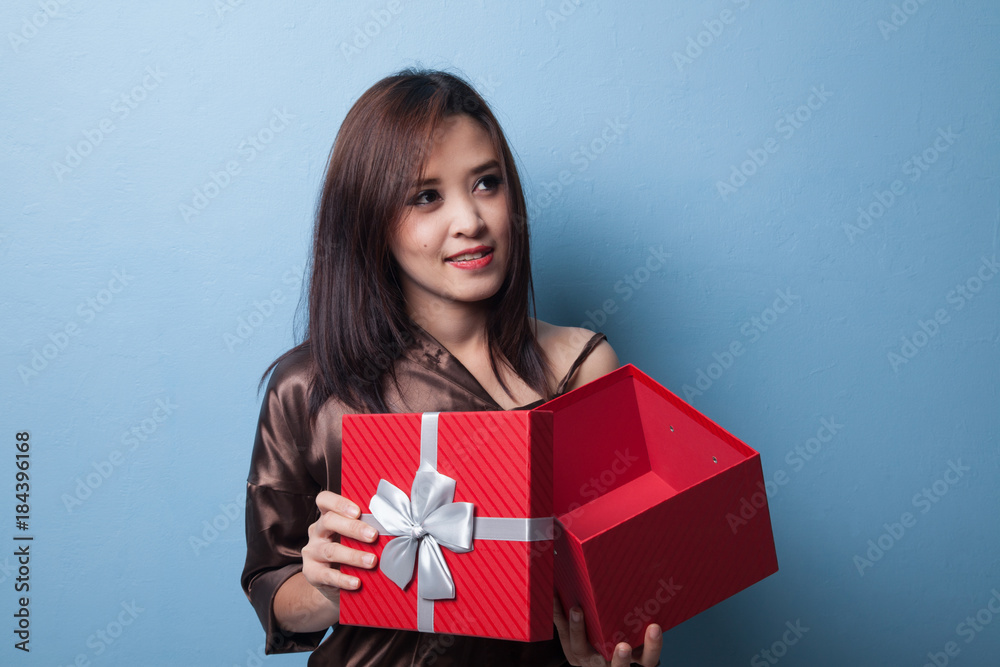 Young Asian woman open a gift box. Young Asian woman open a gift box.
