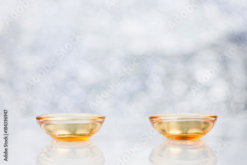 Candles In Glass Cup And Decoration On Blurred Background With Bokeh