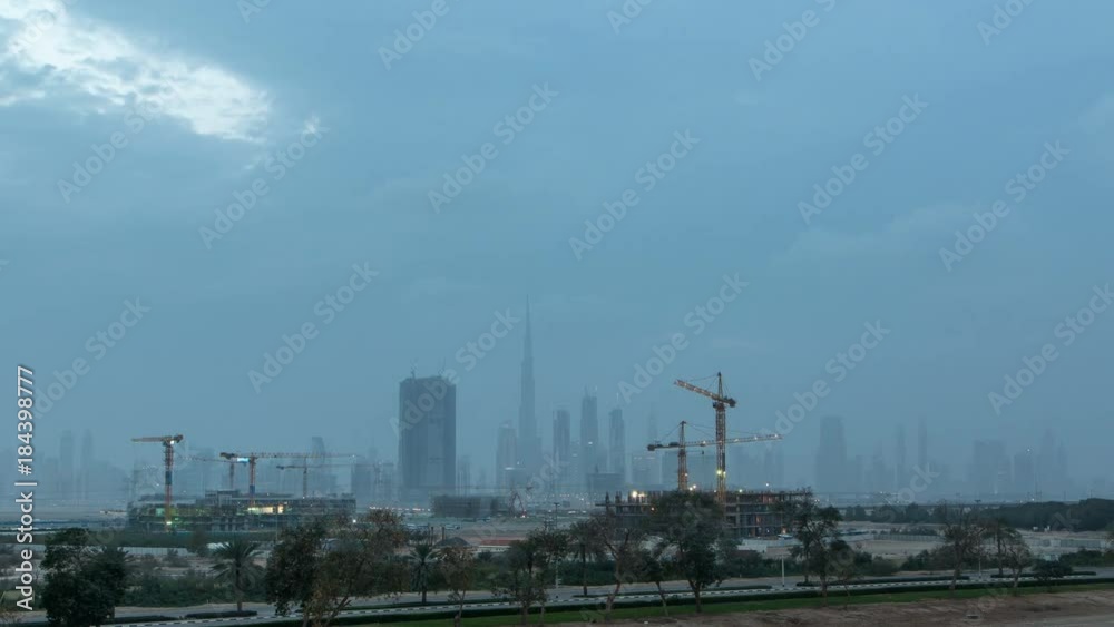 Skyline of construction cranes tower with skyscrapers on background in the Middle East day to night timelapse, Dubai Skyline of construction cranes tower with skyscrapers on background in the Middle East day to night timelapse, Dubai