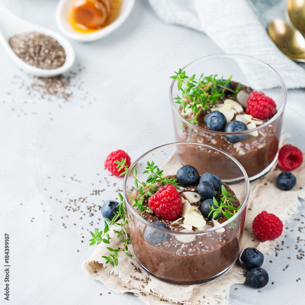 Healthy vegan chocolate chia pudding with berries and green thyme Healthy vegan chocolate chia pudding with berries and green thyme