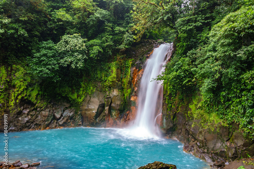 Celestial blue waterfall and pond in tenorio national park, Costa Rica