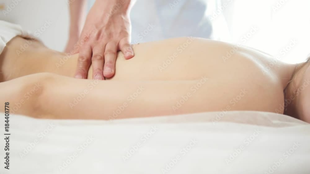 Relaxation massage for back. Man rmassaging for young blonde female Relaxation massage for back. Man rmassaging for young blonde female