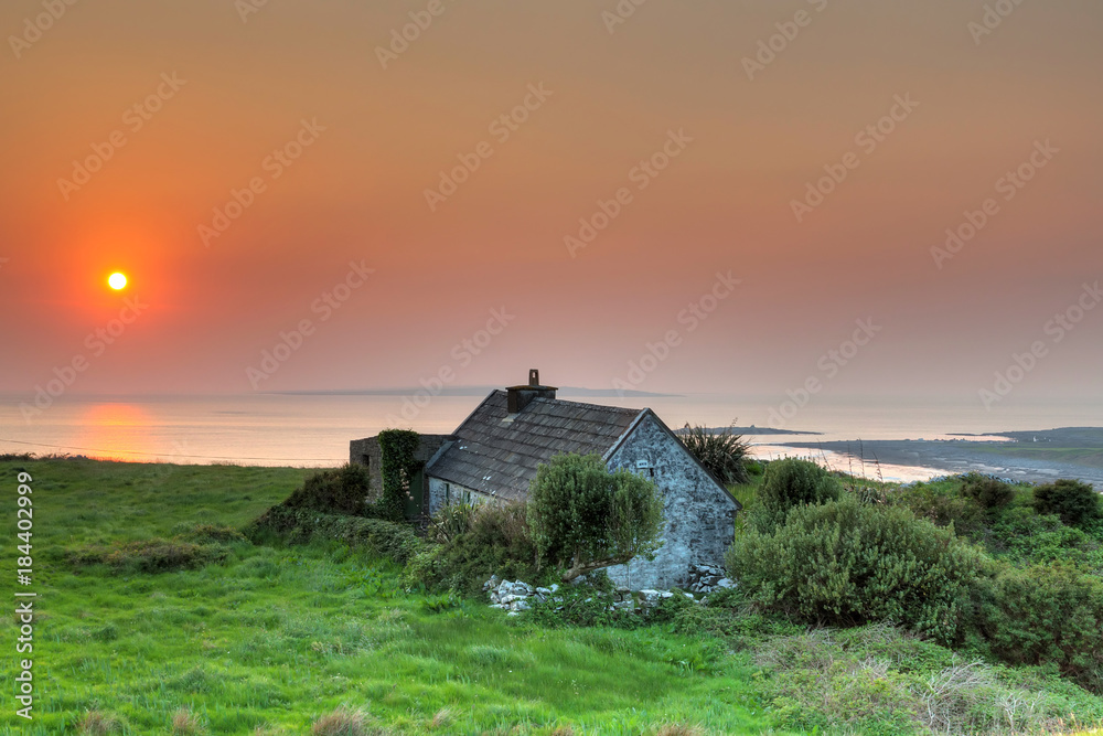 Irish cottage house at sunset