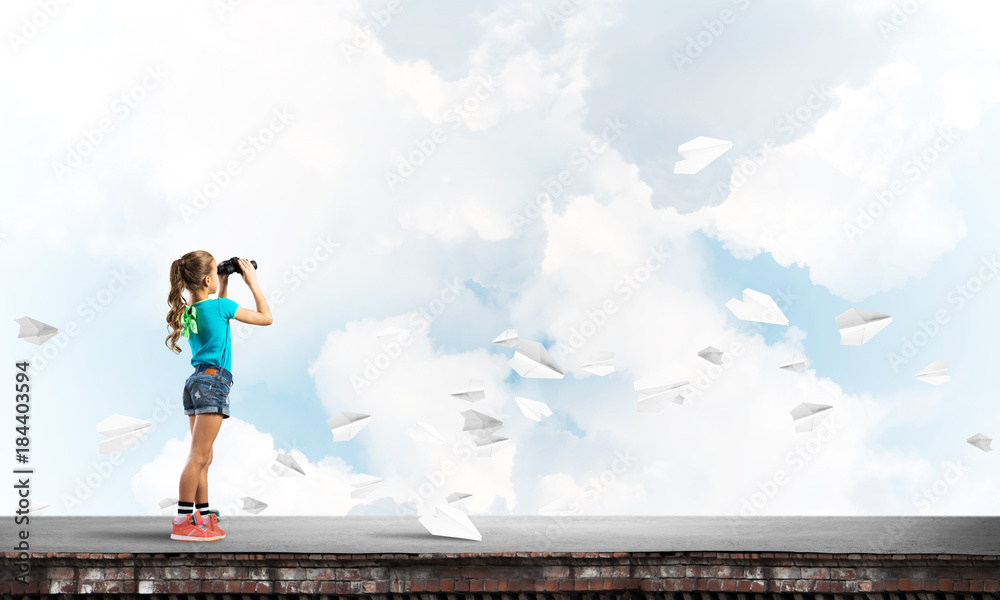 Concept of careless happy childhood with girl of school age looking in future Concept of careless happy childhood with girl of school age looking in future