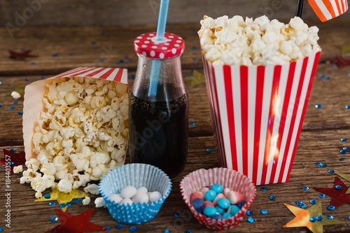 Popcorn, sweet food and cold drink decorated with 4th July theme