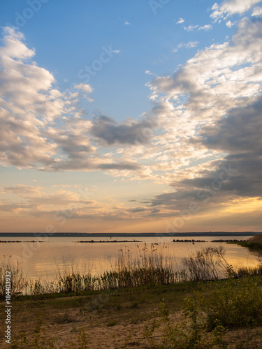 Picturesque view of the river at sunset with cloudy sky