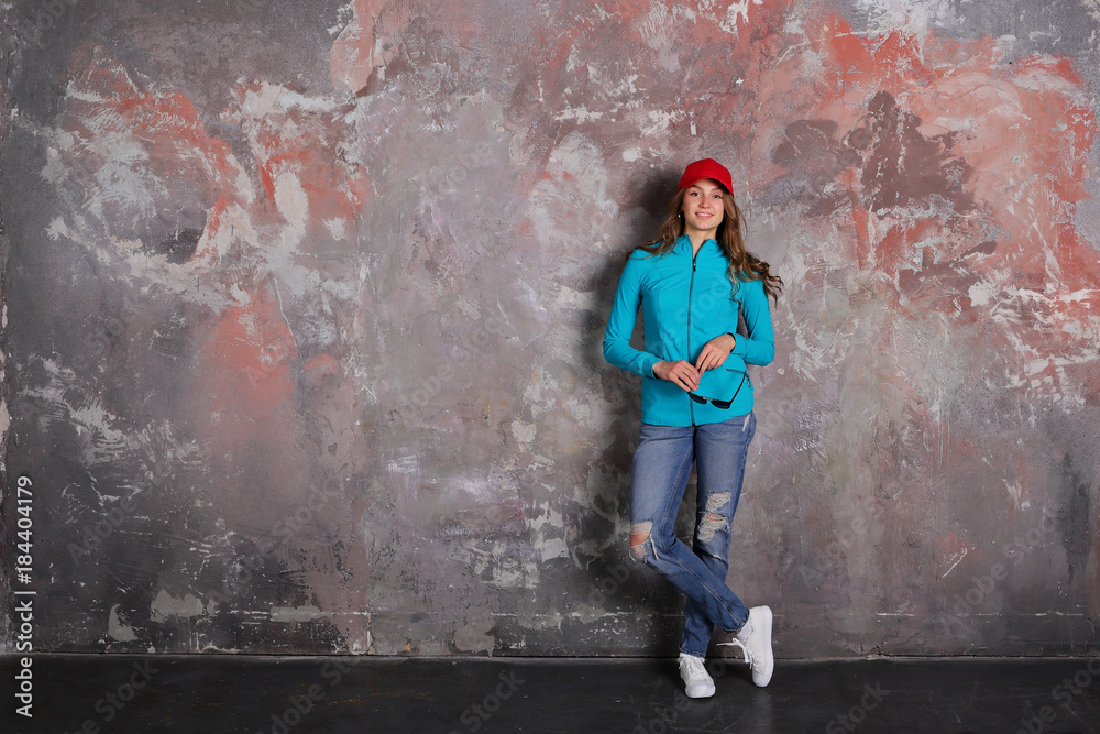 Woman standing full length on loft background, sport, casual style, smiling, copy space