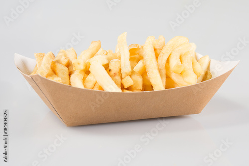 cardboard box of French fries in a takeaway dish of a snack