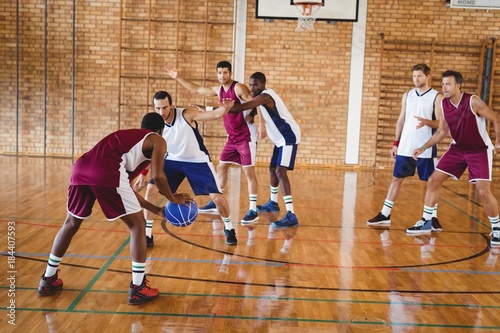 Basketball players playing in the court