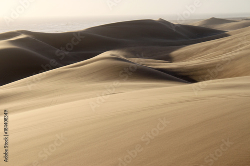 Sanddühnen bei starkem Wind mit fliegenden Sandschleiern.Where: Nähe Swakopmund, Namibia. photo