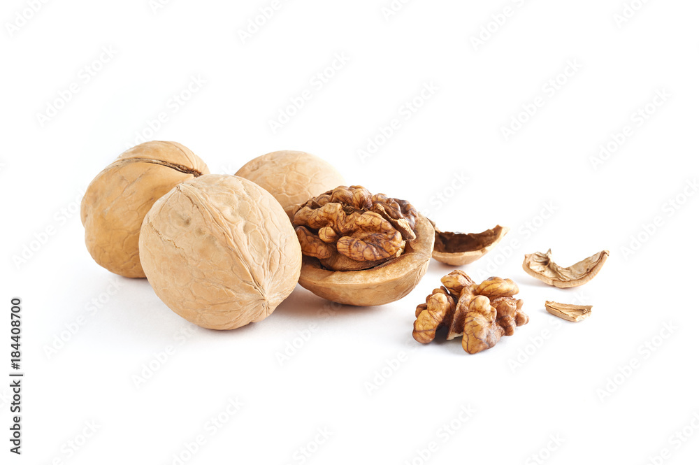 Walnuts and walnuts kernels with shell crumbles isolated on white background.