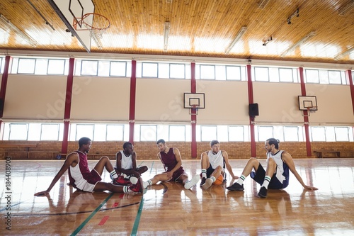 Fototapeta Naklejka Na Ścianę i Meble -  Basketball players interacting while relaxing