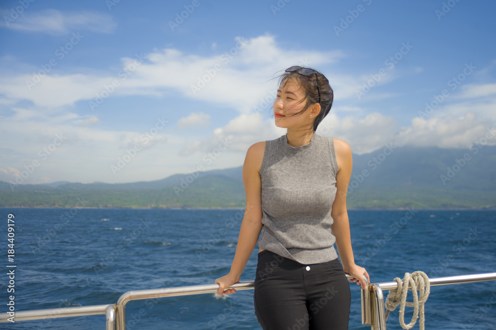 young attractive and happy Asian Chinese woman on excursion ship or ferry enjoying sea breeze on summer holiday sea boat trip young attractive and happy Asian Chinese woman on excursion ship or ferry enjoying sea breeze on summer holiday sea boat trip