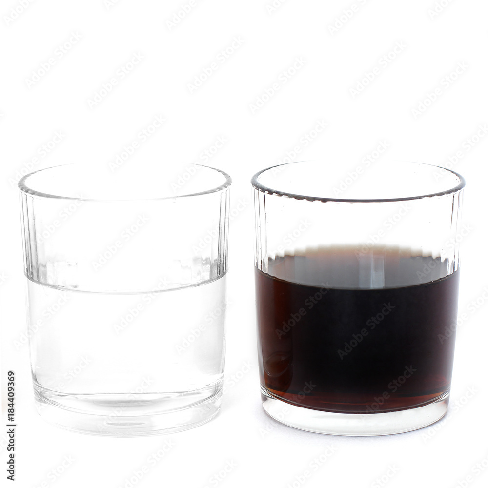 Different drinks in two glasses. Water in a glass on a white background. Drink. Glass Different drinks in two glasses. Water in a glass on a white background. Drink. Glass