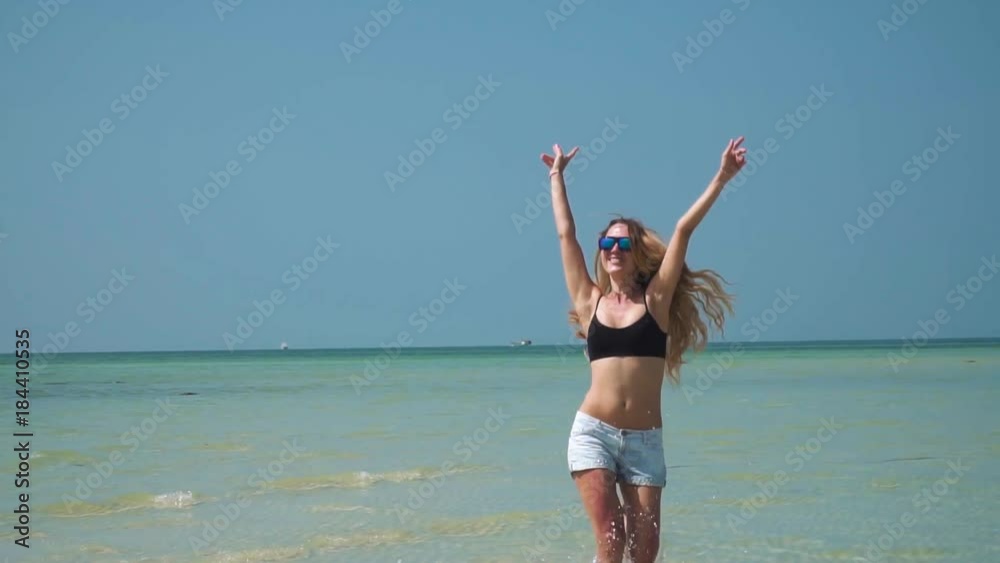 Young Woman Having Fun by Shallow Tropical Sea Young Woman Having Fun by Shallow Tropical Sea
