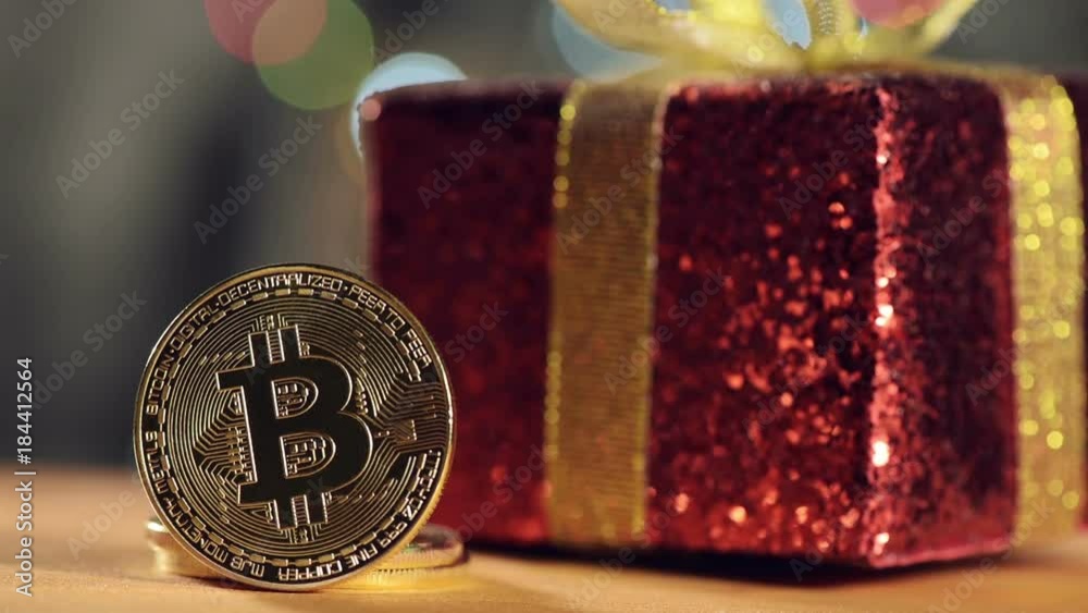 Bitcoin BTC cryptocurrency and Christmas gift box, BTC golden coin as symbol of electronic virtual money for web banking and international network payment