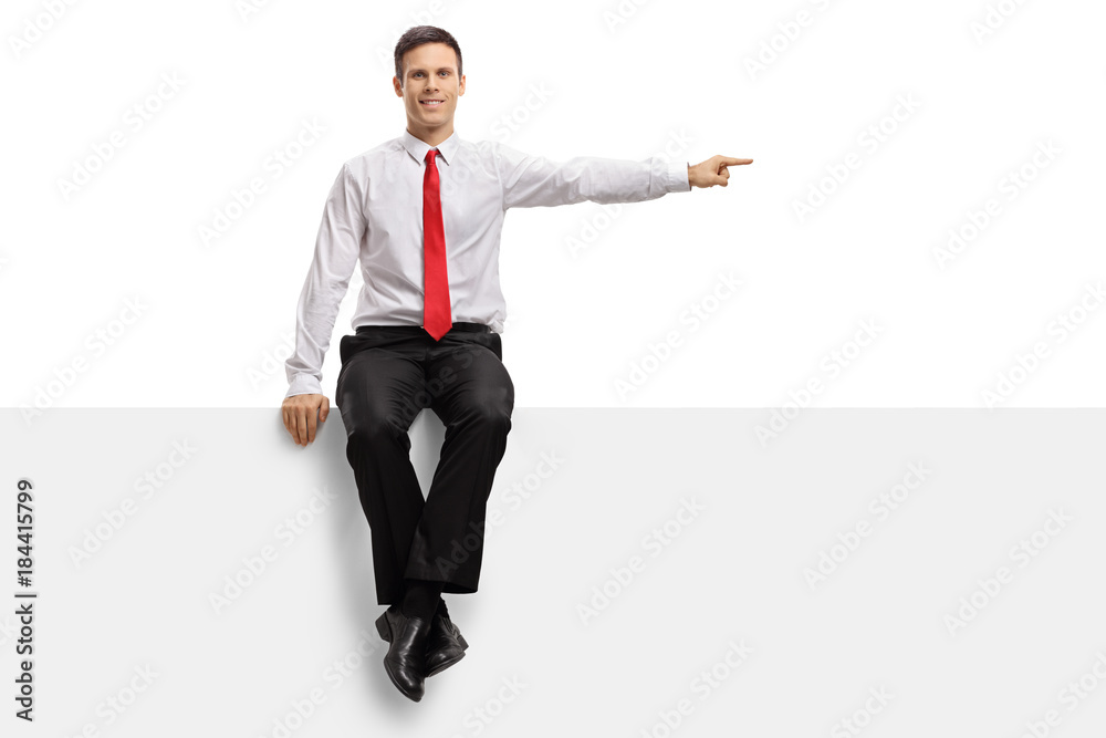 Formally dressed guy sitting on a panel and pointing Formally dressed guy sitting on a panel and pointing