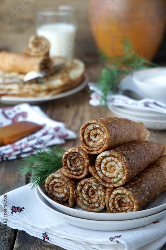 Russian pancakes with dill wrapped in rolls