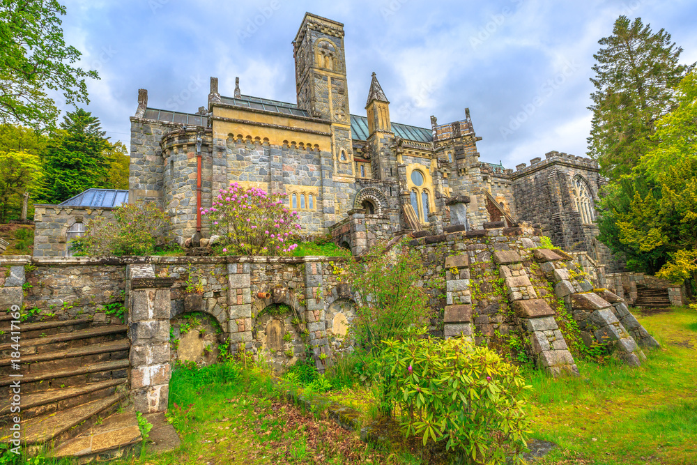 Obraz premium Scenic backside garden of Saint Conan's Kirk church, located in Loch Awe in Argyll town of Scotland in United Kingdom, Europe. Spectacular landmark on scottish highlands. Dramatic sky.
