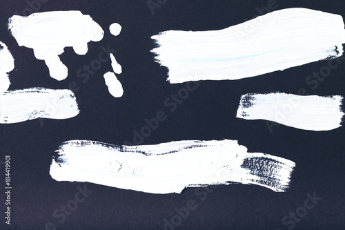 abstract painting with white brush strokes on black
