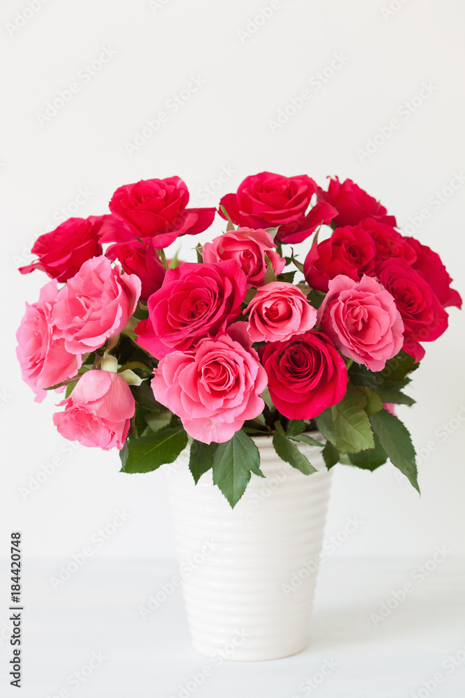 beautiful red rose flowers bouquet in vase over white