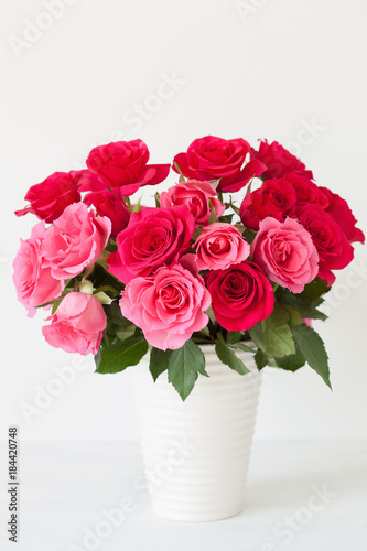 beautiful red rose flowers bouquet in vase over white