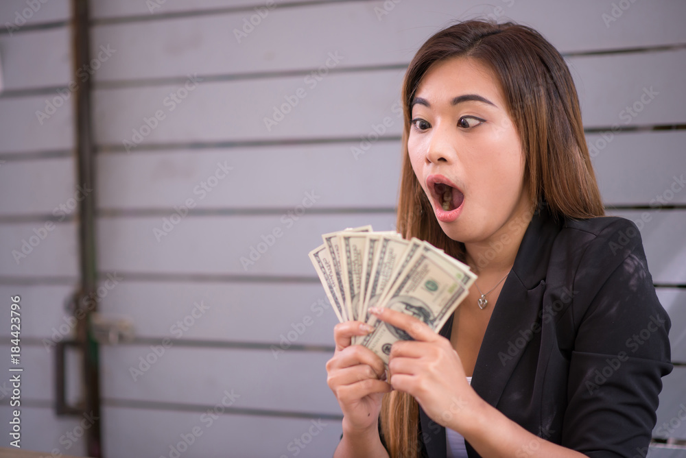 Businesswoman glad to receive money from work, excitement. Selected focus