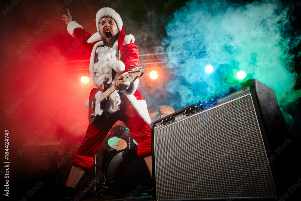 Santa Claus plays rock.