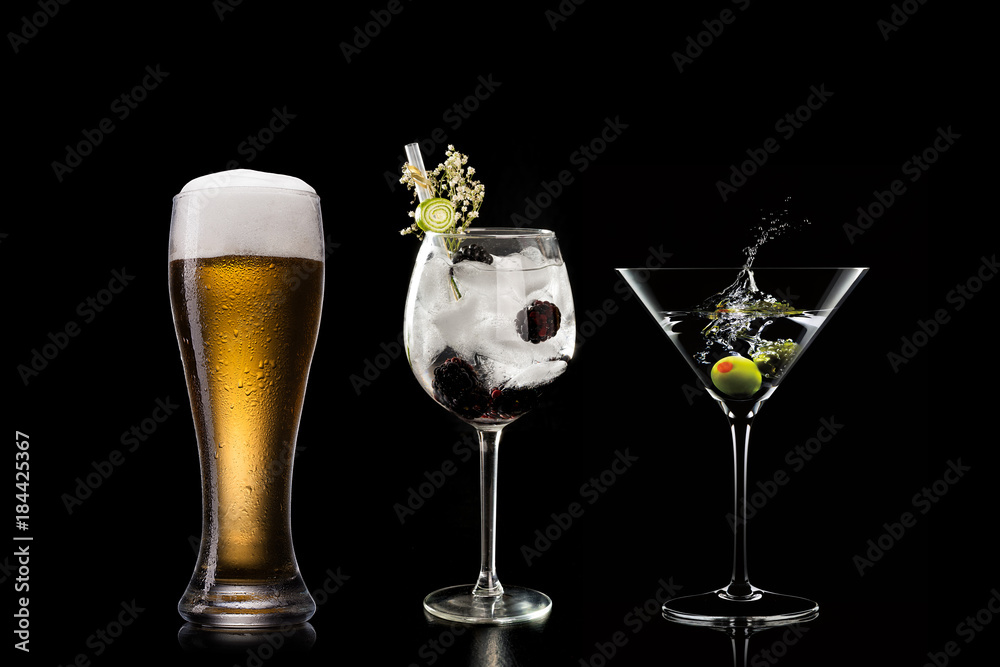 Selection of cocktails martini spritz bramble gin tonic beer bramble bar blurred black background
