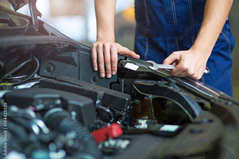 Hands of mechanic working in auto repair shop
Hands of mechanic working in auto repair shop