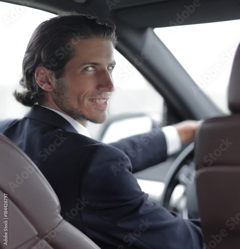 man sitting behind the wheel of a car © ASDF