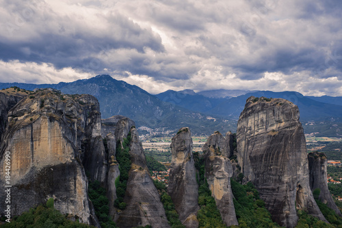 Landscape of monasteries of Meteora in Greece in Thessaly at the early morning. Cliffs of Meteora opposite a morning cloudy sky background