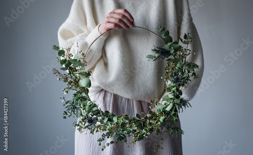 Midsection of woman holding wreath photo
