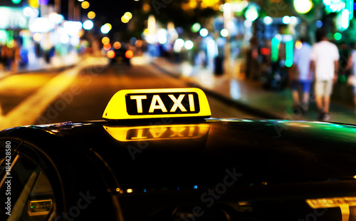 Fotografie Taxi in the evening on the street