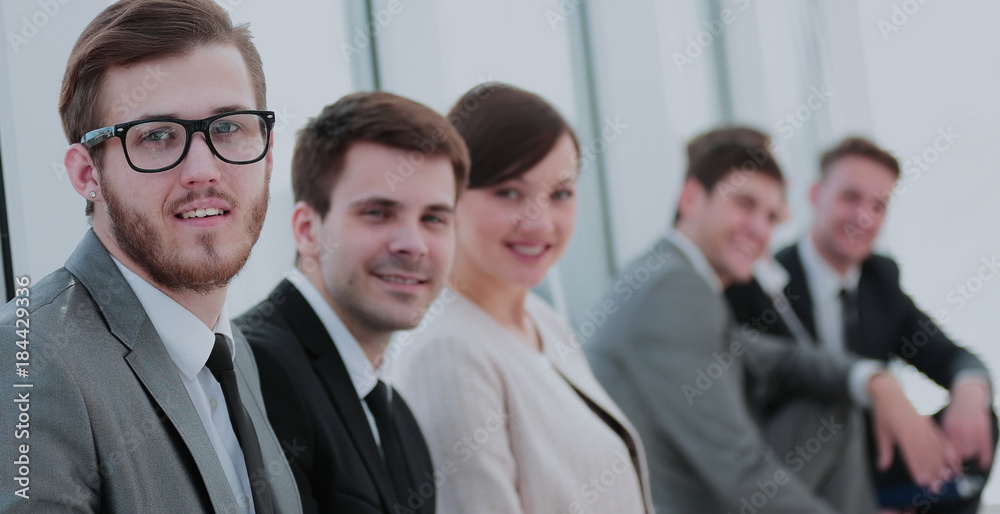 Smiling and confident business team having time break in front o Smiling and confident business team having time break in front o