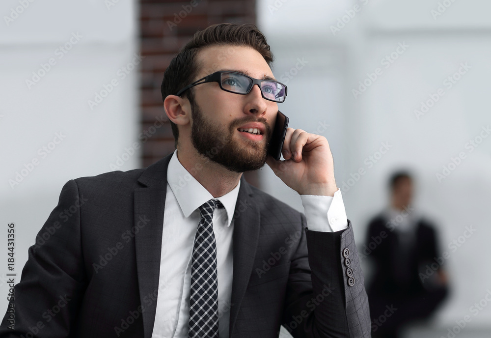 View of a Young attractive business man using smartphone View of a Young attractive business man using smartphone