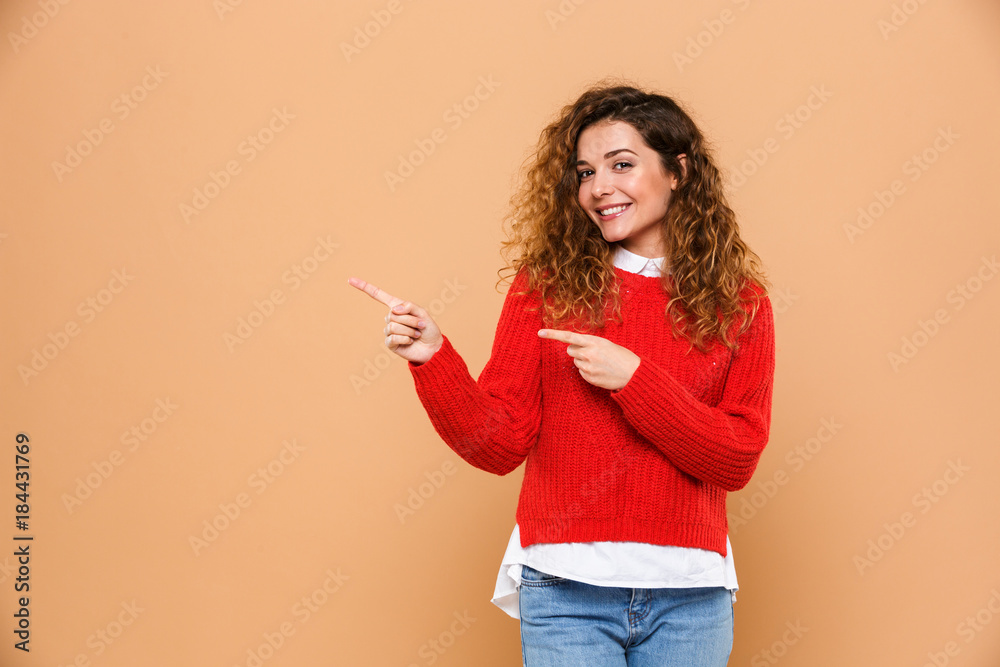Portrait of a happy pretty girl standing and pointing Portrait of a happy pretty girl standing and pointing
